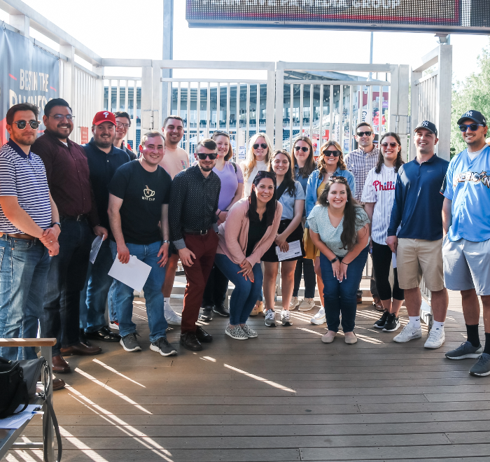 A large group of Brown Plus team members in casual clothing at a recruitment event