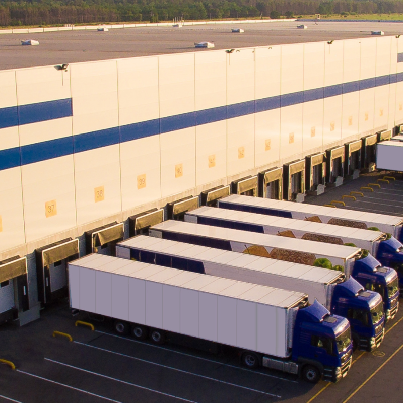 Semi-truck trailers docked at a warehouse